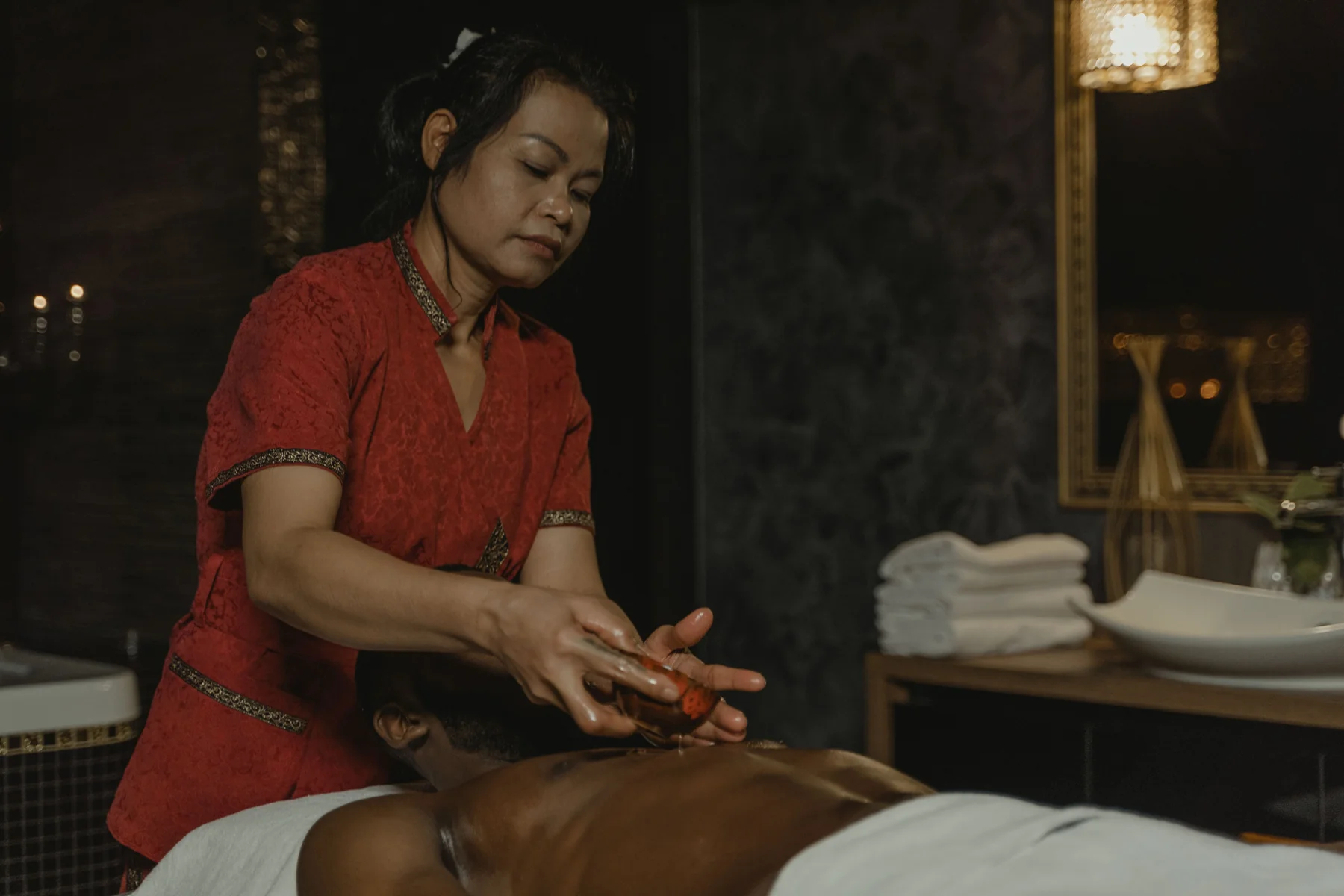 Professional massage specialist preparing a spa session